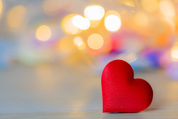 Fototapeta premium Red heart shape on wood table with soft bokeh
