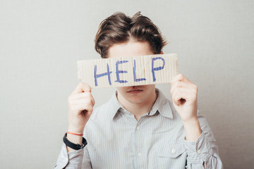 man holding a cardboard with the inscription help