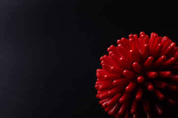 Red coronavirus molecule model on black background with copy space.