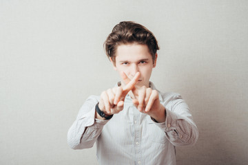 man hands crossing fingers forming an x
