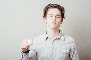 Young Business Man Drinking a Cup of Coffee or Tea