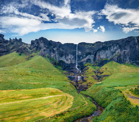 Naklejka premium View from flying drone. Amazing summer view of Foss a Sidu Waterfall. Dramatic morning landscape of Iceland, Europe. Beauty of nature concept background.
