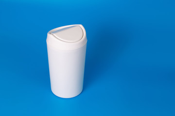 Small table white trash can on a blue background