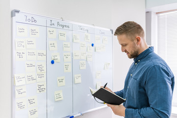 Businessman Writing On Sticky Notes