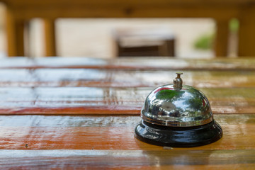 Bell on the wood table in restaurant with nature