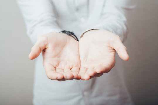 man's hands holding something invisible