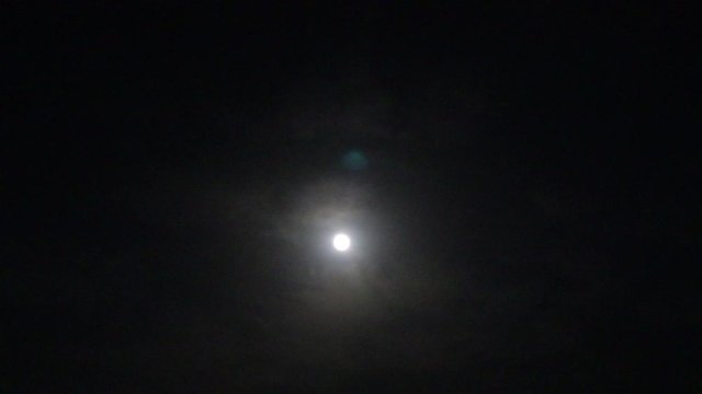 clouds time lapse under the moon in night, selective focus point background