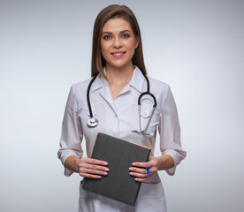 smiling woman doctor in white uniform holding books.