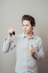 young man holding a key