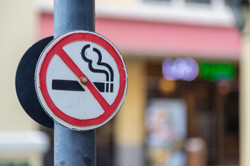 Old No Smoking Label Stick to the pole in the public park