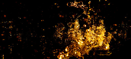 Golden water with splashes as an abstract background.