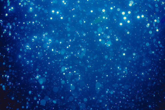 Abstract blue defocused bokeh of lights in dark