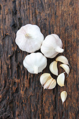 fresh garlic on wood background. Concept with vitamin and energy food for saving from COVID-19 virus.