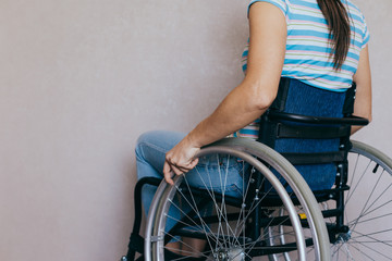 Obraz premium Unrecognizable disabled woman in wheelchair at home. Recovery and healthcare concepts.