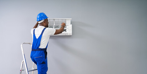 Technician Repairing Air Conditioner