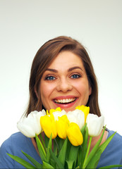 portrait of smiling woman holding tulips flowers in front of face