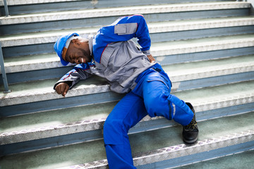 Worker Man Lying On Staircase