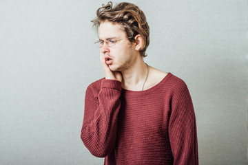 Man toothache. On a gray background.