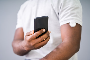 Man Checking Blood Sugar Level On Smart Phone