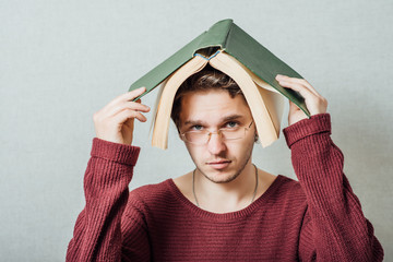man with a book on his head