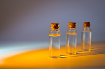 Three glass corked bottles filled with liquid. Background for science and medicine. Virus vaccine.