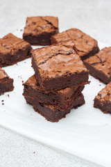 Freshly baked chocolate chewy brownie, cut into nine square pieces.