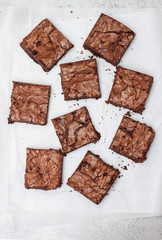 Freshly baked chocolate chewy brownie, cut into nine square pieces.