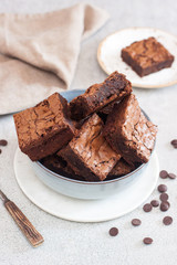 Freshly baked homemeade hocolate chewy brownie in grey bowl.