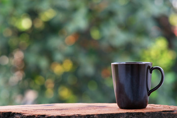 cup of coffee on wood counter background and space for text
