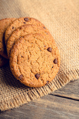 Fresh and healthy cookies with chocolate and seeds on the rustic background. Selective focus. Shallow depth of field.
