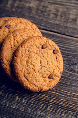 Fresh and healthy cookies with chocolate and seeds on the rustic background. Selective focus. Shallow depth of field.

