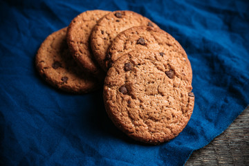 Fresh and healthy cookies with chocolate and seeds on the rustic background. Selective focus. Shallow depth of field.
