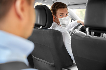 health protection, safety and pandemic concept - male taxi driver wearing face protective medical...
