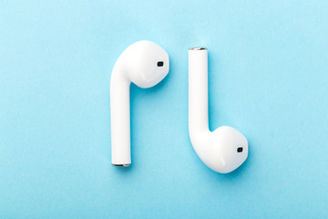  wireless bluetooth headphones lie on a blue background