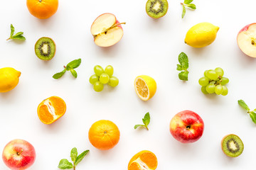 Colorful fruit pattern. Cut apple, kiwi, citrus on white background top-down