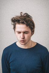 man sucks his cheeks
