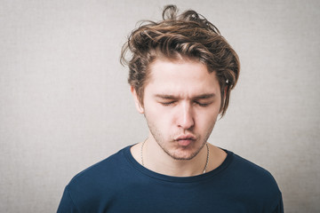 man sucks his cheeks