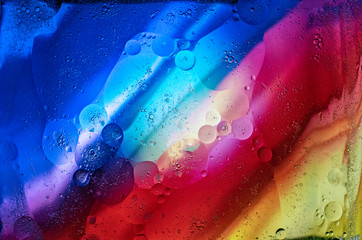 A graphic resource for a background of diagonally slanted multi-colored stripes with the effect of water and oil blurring.