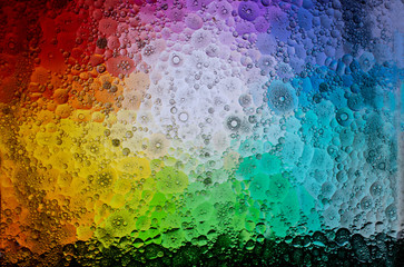 A graphic resource for a background of multi-colored paint spots with the effect of water and oil blurring.