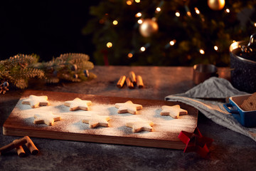 Freshly Baked Star Shaped Christmas Cookies On Board Dusted With Icing Sugar