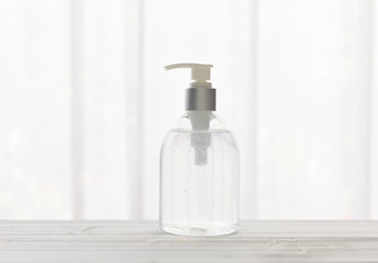 Hand sanitizer bottle or alcohol gel on white wood background for Coronavirus disease (COVID-19) prevention.