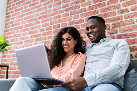 Happy Mature Couple Working On Laptop