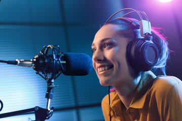 Young woman working at the radio station - obrazy, fototapety, plakaty