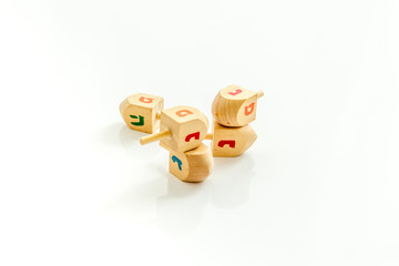 Dreidels - wooden symbol of Jewish holiday Hanukkah - on white background copy space