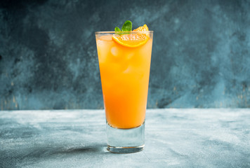 Fresh cocktail with vodka and orange juice on the rustic background. Selective focus. Shallow depth of field.