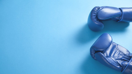 Boxing gloves on blue background. Space for your text