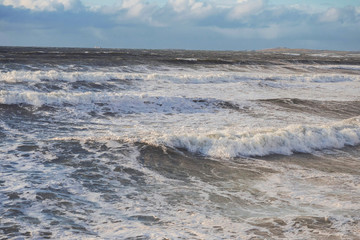 Ocean surface with waves and clouds in the background. Nature landscape, West coast of Ireland.