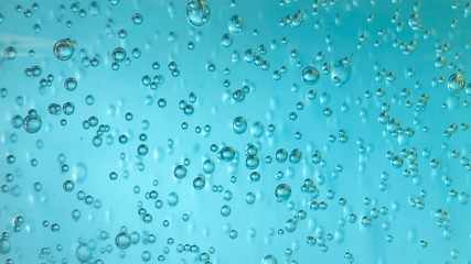 Air bubbles in alcohol gel.  Abstract background water drops on blue water.