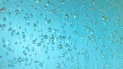 Air bubbles in alcohol gel.  Abstract background water drops on blue water.