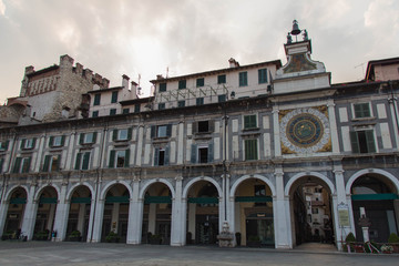Fototapeta na wymiar Arcades and clock tower in Piazza della Loggia, Brescia, Lombardy, Italy.